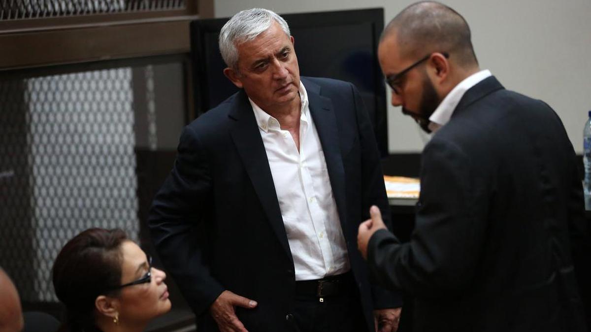 El ex presidente de Guatemala Otto Pérez Molina (c) y la ex vicepresidenta Roxana Baldetti (izq.) conversan con su abogado Fernando Guerra durante una audiencia por el caso de corrupción.
