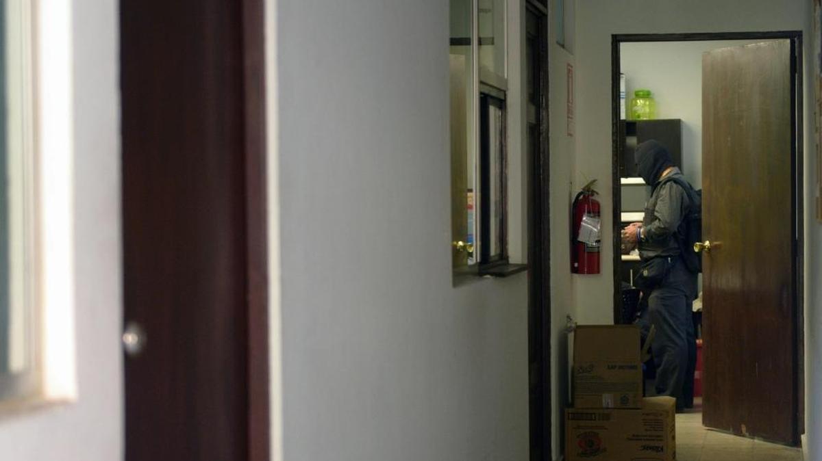 Un agente policial participa en el allamiento a las oficinas del bufete panameño Mossack Fonseca en El Salvador, el viernes.