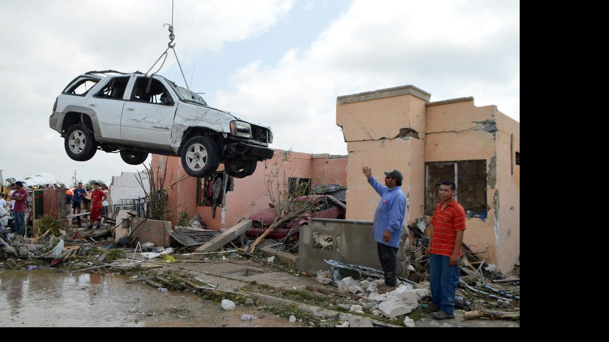 
Una grúa levanta un vehículo tras el paso de un tornado el lunes en Ciudad Acuña, norte de México. Esa ciudad sufrió el impacto de un tornado que afecto a cientos de familias. Un tornado ‘atípico’ por su intensidad dejó por lo menos 14 personas muertas en esa ciudad del norteño estado mexicano de Coahuila.
