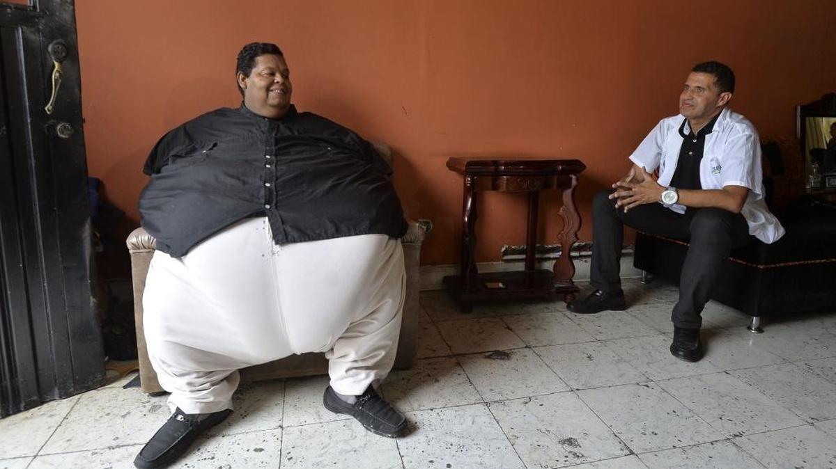 Óscar Vásquez Morales (izq.), quien pesa 400 kilos, habla con Salvador Palacio director de la fundación “Gorditos de Corazón”, en Palmira, Colombia.