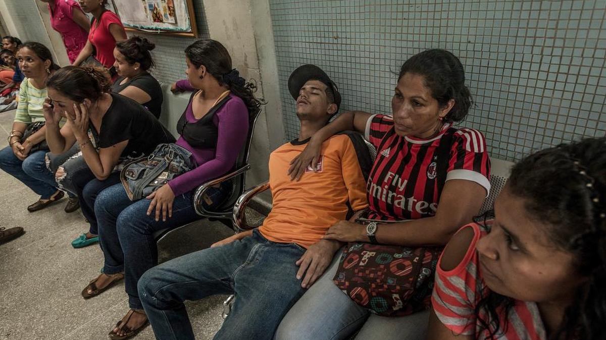Maribel Supero y su hijo esperan junto a otras personas, muchos de ellos afectados de malaria, por atención médica en un hospital en Ciudad Guayana, Venezuela, el 24 de mayo de 2016.
