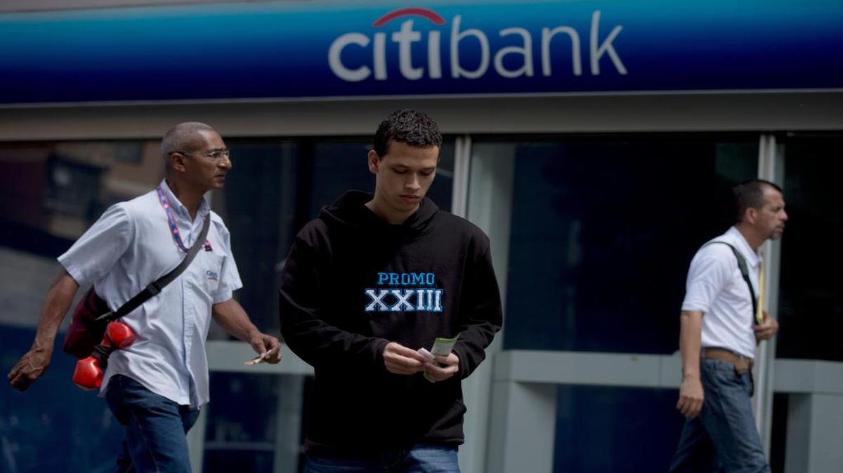Un cliente cuenta bolívares a las afueras de una sucursal del Citibank en Caracas el 12 de julio del 2016.