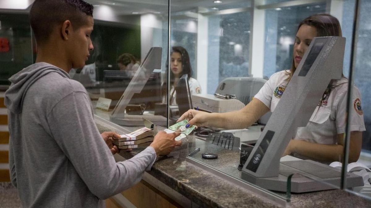Trabajadores de un banco manipulan billetes del nuevo cono monetario el16 de enero de 2017, en Caracas (Venezuela).