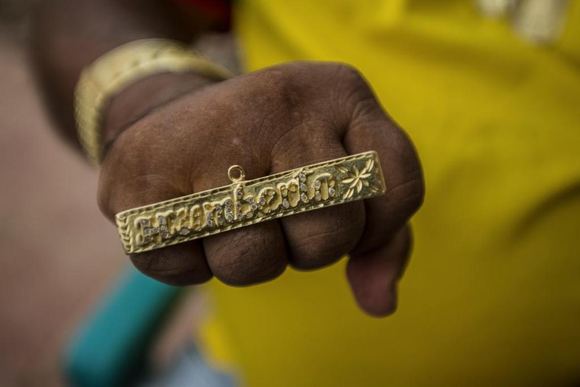 The leader of the Syndicate, one of many armed groups that feed off the mining industry, shaking down those who mine and transport the gold, shows off the fruits of his efforts.