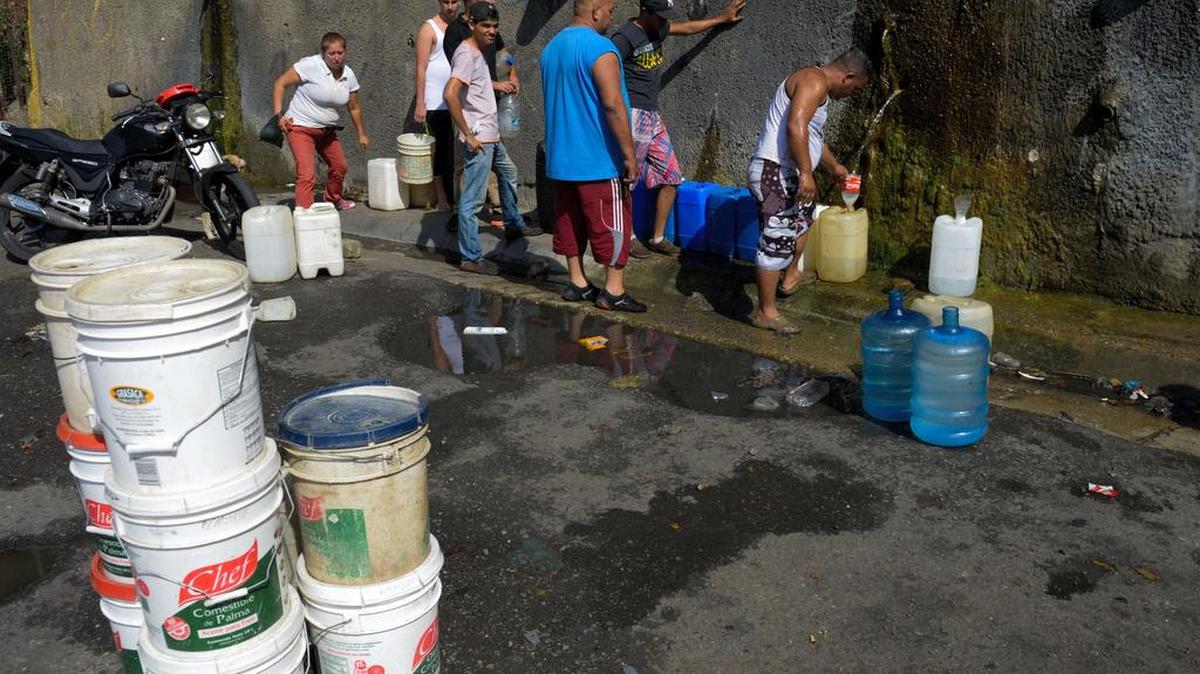 La gente hace fila para llenar sus recipientes con agua potable en la región de Wuaraira Repano, en Caracas, el 21 de enero del 2016.