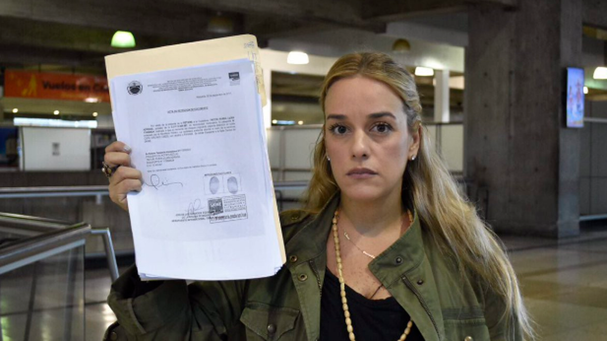 Lilian Tintori, activista política y esposa del dirigente opositor venezolano privado de libertad Leopoldo López, muestra el documento que justifica la prohibición de salida de Venezuela.