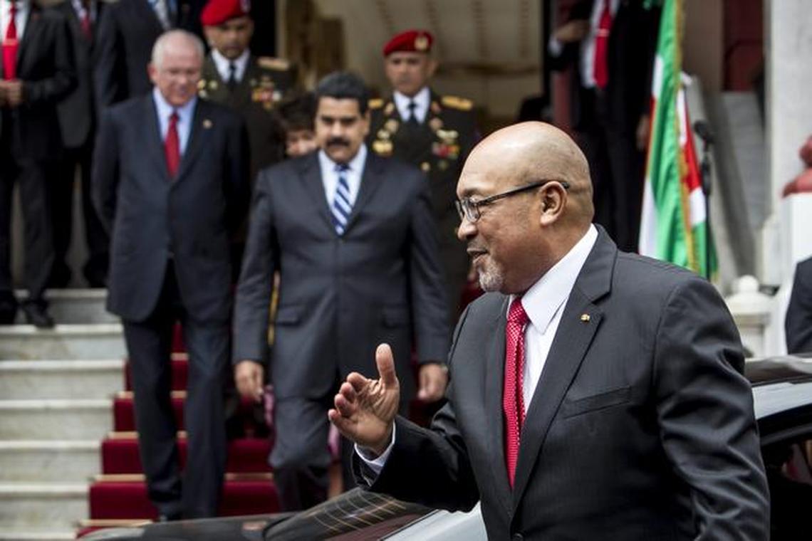 In this archive photo, Suriname President Desire “Desi” Bouterse, right, arrives at a swearing-in ceremony for UNASUR, the regional grouping known as the Union of South American Nations.