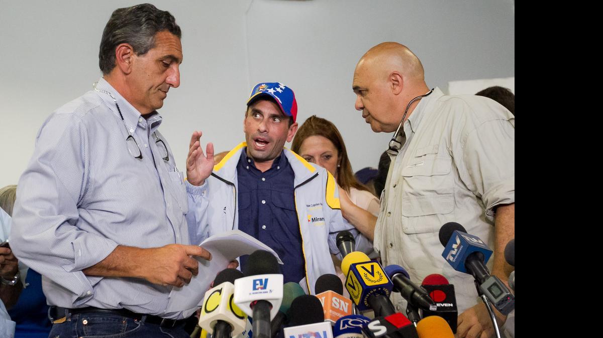 
El excalde venezolano destituido de su cargo, apresado en marzo del año pasado y liberado diez meses después, Vicenzo Scarano (i) asiste a una rueda de prensa hoy, 17 de julio del 2015, junto al secretario de la Mesa de Unidad Democrática (MUD) Jesus Torrealba (d) y el dos veces candidato presidencial venezolano Henrique Capriles (c) en Caracas (Venezuela). La alianza Mesa de la Unidad Democrática (MUD) anunció hoy que denunciará ante organismos internacionales las inhabilitaciones políticas impuestas por la Contraloría General de Venezuela a tres de sus dirigentes opositores, que aspiran a ser candidatos en las elecciones legislativas el próximo 6 de diciembre. 
