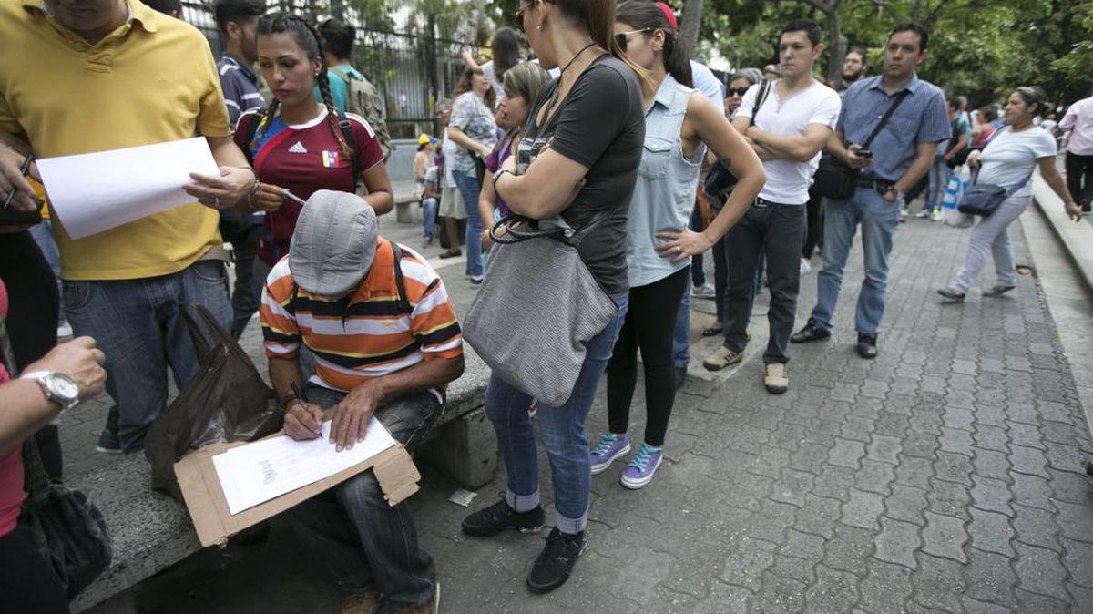 Venezolanos hacen fila para firmar una iniciativa para pedir el revocatorio del presidente Nicolás Maduro, el 27 de abril en Caracas, Venezuela.