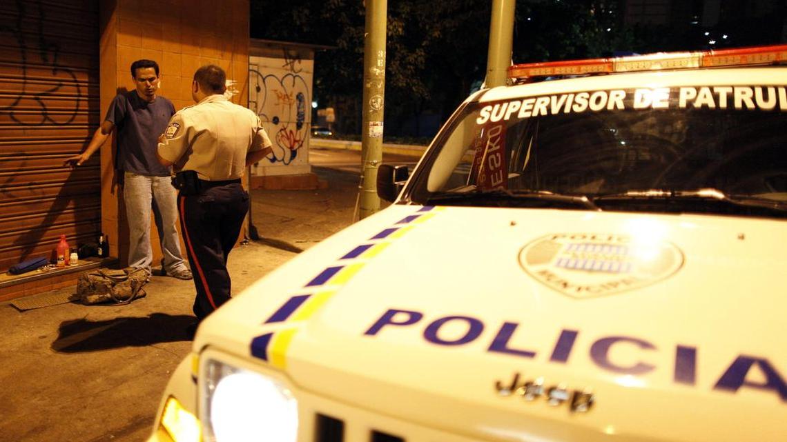 Foto de archivo. Un inspector de la Policía Municipal de Sucre, Caracas, comprueba la identidad de un sospechoso en el violento barrio de Petare en Caracas, en esta foto de archivo del 2009.