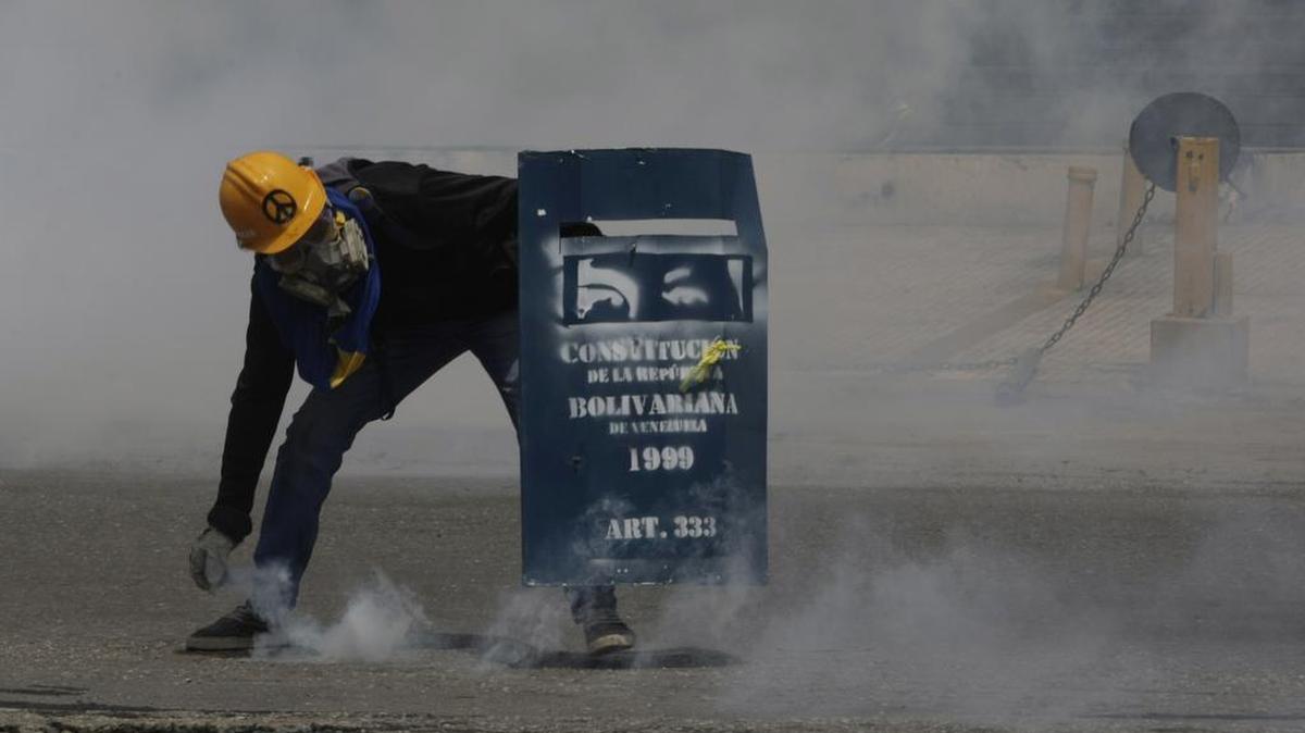 Un manifestante usa un escudo decorado como la constitución de Venezuela, en Caracas, el miércoles 24 de mayo de 2017.