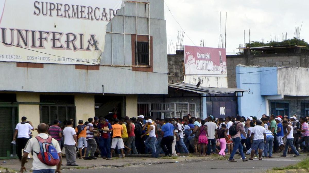 
Un grupo de personas saquea el viernes un supermercado en la población de San Félix, estado Bolívar, en el sur de Venezuela. Una persona resultó muerta y otras 60 fueron arrestadas por efectivos de la Guardia Nacional.
