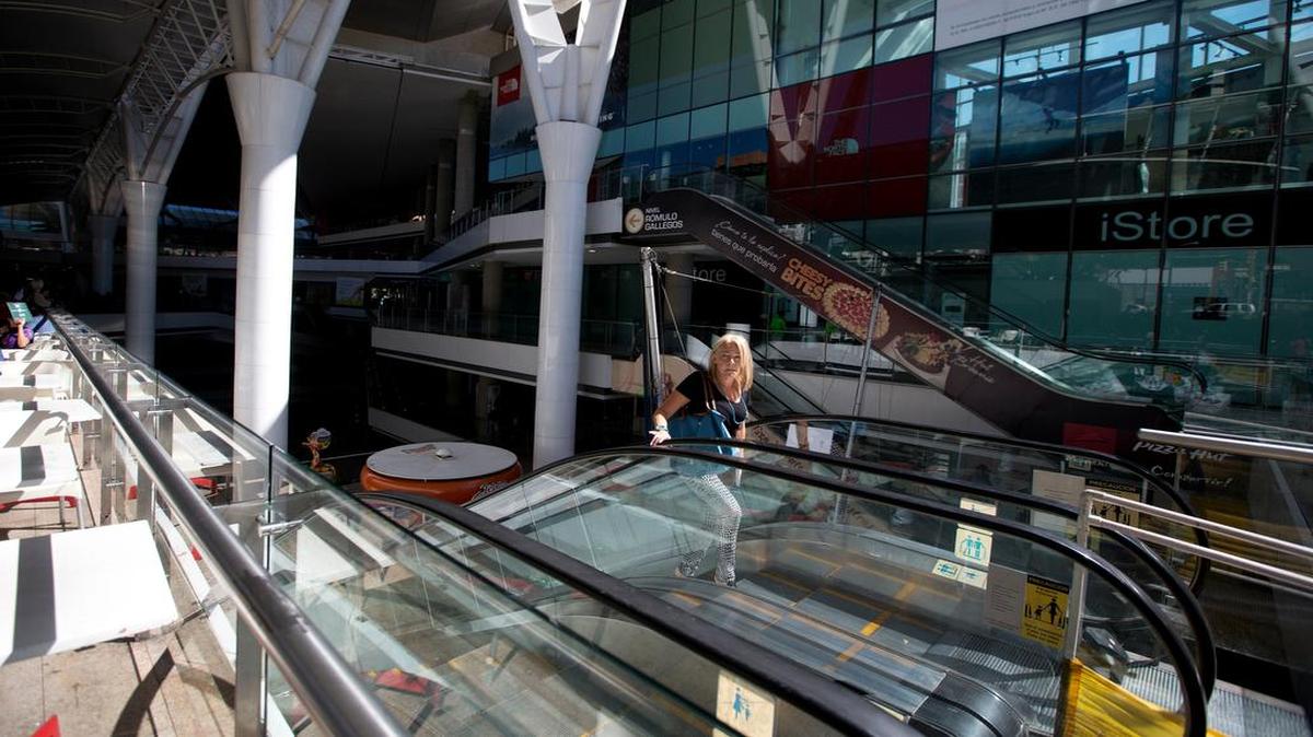 Una empleada sube por una escalera eléctrica en un centro comercial cerrado en Caracas el 10 de febrero del 2016.