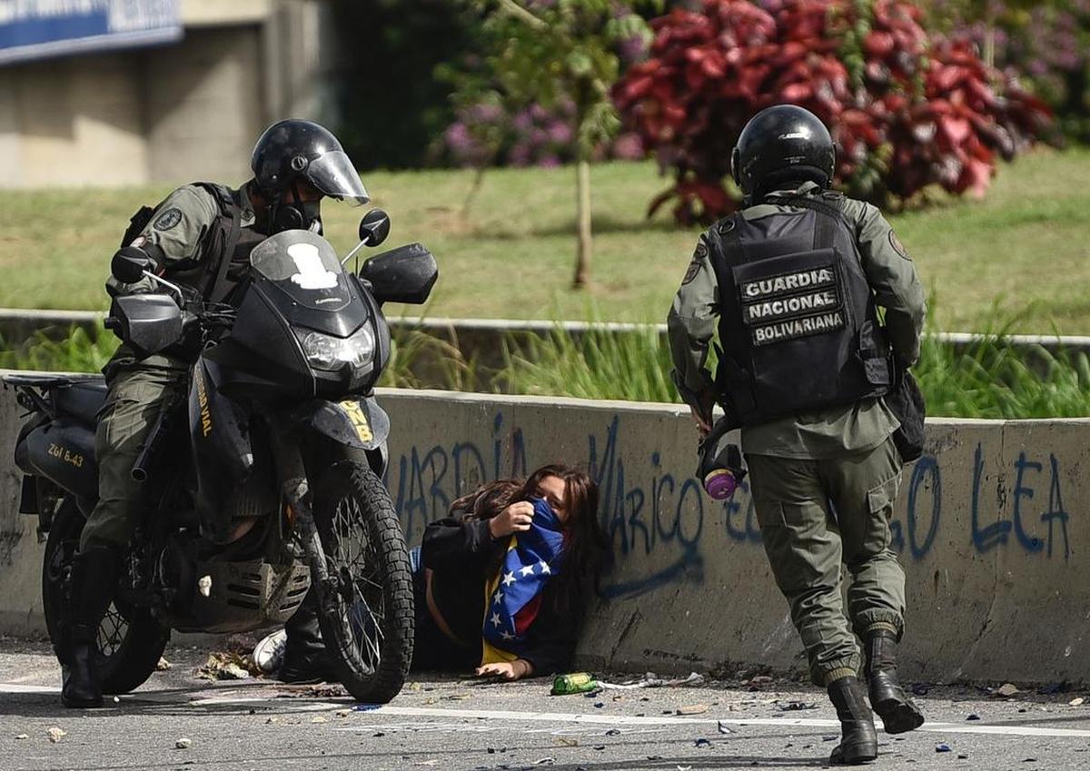 Un miembro de la Guardia Nacional Bolivarian arresta a una manifestante el lunes en Caracas, Venezuela. Tras una ola de protestas que ya lleva 101 días, al menos 93 personas han muerto y miles han sido detenidos.