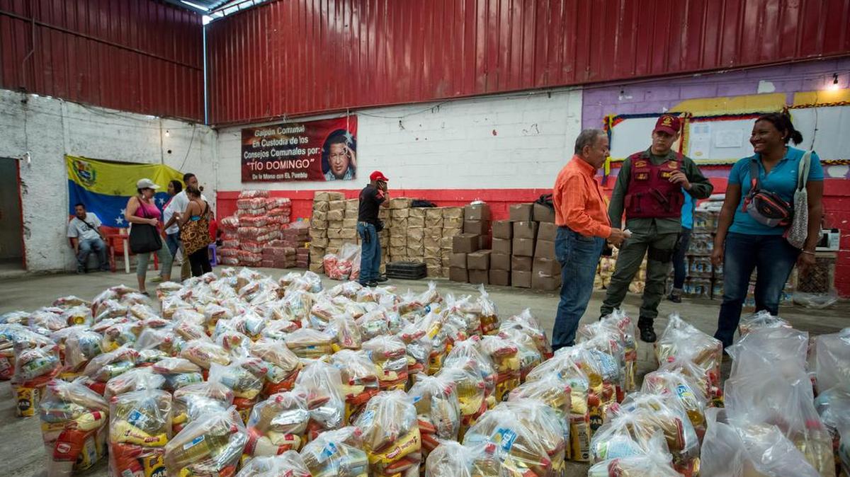 Fotografía del 20 de agosto del 2016, donde se observan un operativo de entrega de bolsas de comida a habitantes de un barrio del km 3 del Junquito por parte Comités Locales de Abastecimiento y Producción (CLAP) en Caracas (Venezuela).
