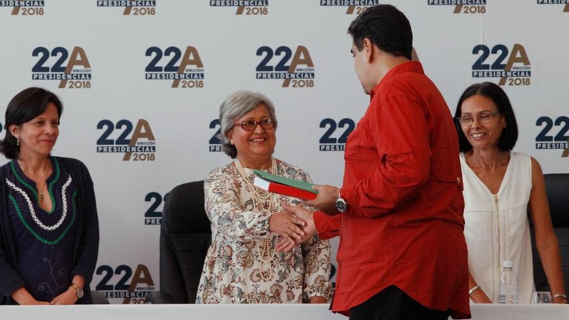 La presidenta del Consejo Nacional Electoral de Venezuela, Tibisay Lucena, estrecha la mano del gobernante Nicolás Maduro, quien oficializó su candidatura a la presidencia el 27 de febrero del 2018.