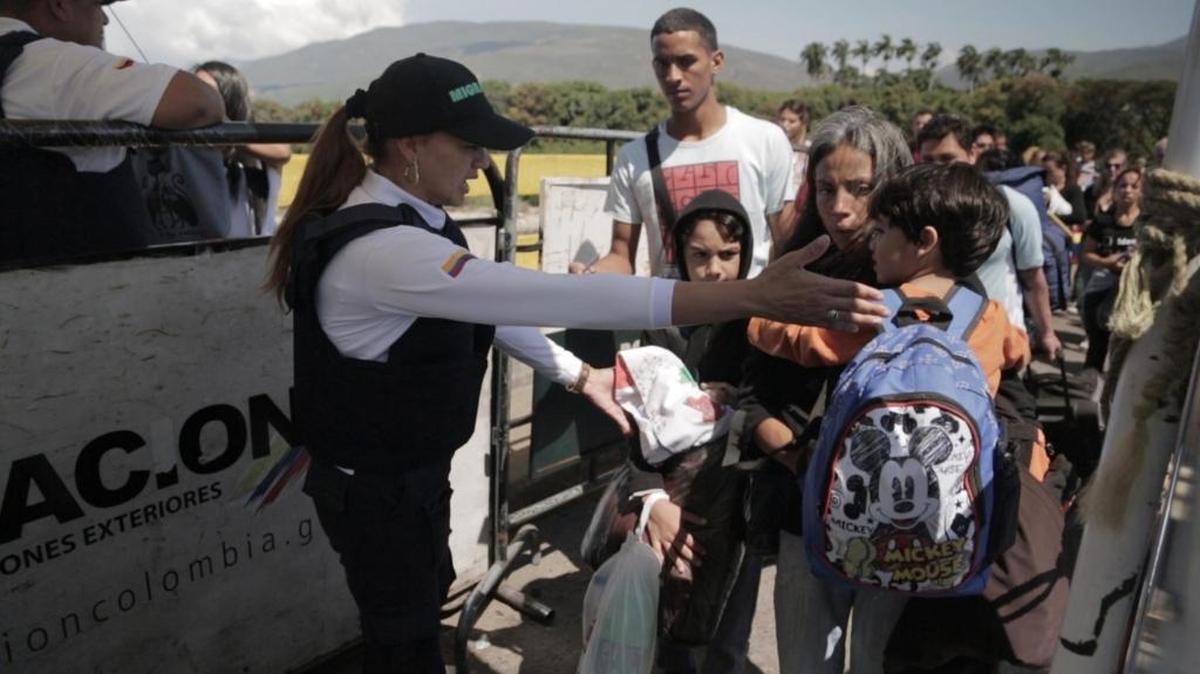 Una funcionaria colombiana orienta a una familia venezolana en el puesto fronterizo al pie del Puente Internacional Simón Bolívar, en Cúcuta, Colombia, el 29 de enero del 2018.