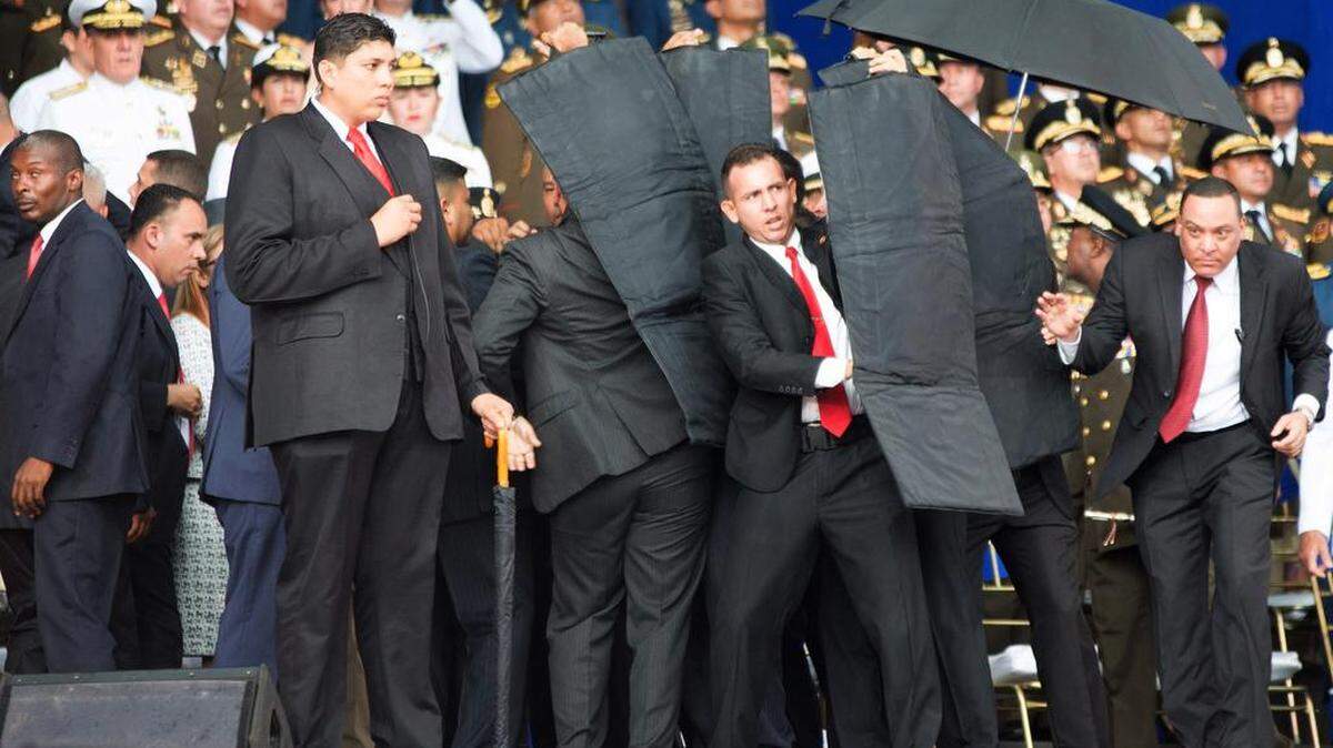 Security members protect Venezuelan President Nicolas Maduro after his speech was interrupted in Caracas, Venezuela on Saturday, Aug. 4, 2018. Six people were arrested after an attack Maduro said was aimed at him. (Xinhua/Zuma Press/TNS)