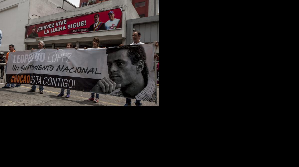 
Un grupo de personas manifiestan su apoyo al dirigente de la oposición venezolana, Leopoldo López, con una pancarta con la imagen de éste, a las afueras del Palacio de Justicia hoy, martes 30 de septiembre de 2014, donde continúa el juicio penal contra López, en la ciudad de Caracas (Venezuela).
