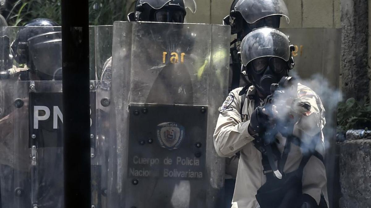 Agentes policiales tratan de reprimer una protesta opositora el jueves en Caracas, Venezuela.