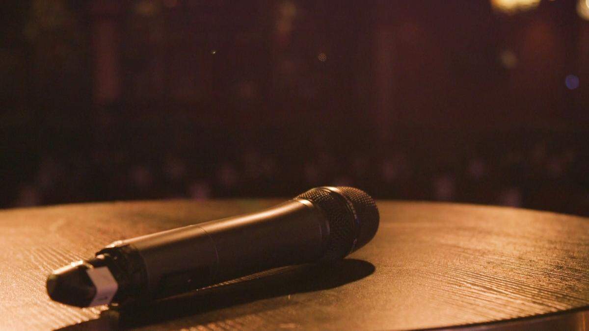 Un micrófono espera por George Harris en el escenario de Flamingo Theater Bar