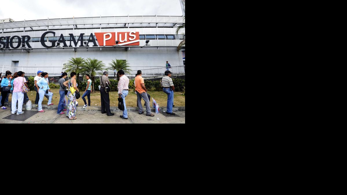 
Decenas de personas hacen fila en un supermercado en Caracas, el jueves 8 de enero de 2015. 
