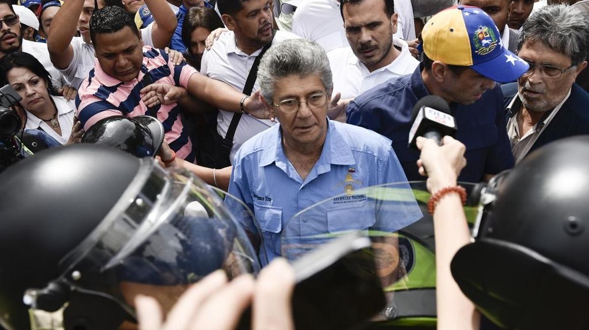 Henry Ramos Allup, presidente de la Asamblea Nacional de Venezuela, y Henrique Capriles, a su derecha, confrontan a la Policía Nacional que bloquea el paso de la marcha.