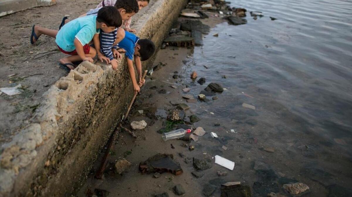 Un grupo de niños juega en las aguas de la Bahía de Guanabara en Rio de Janeiro, la principal puerta al turismo en Brasil. La ciudad enfrenta un grave problema en el tratamiento de aguas residuales, que ha empeorado en décadas recientes con la inmigración de las zonas rurales a las metropolitanas.