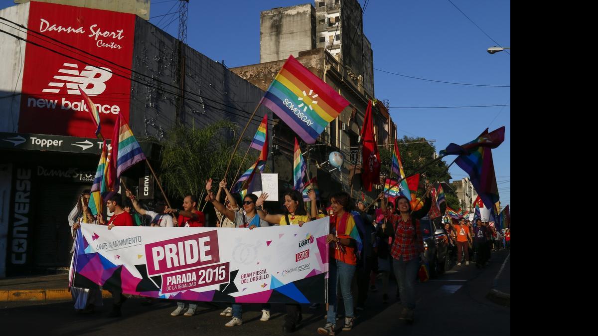 
Homosexuales desfilan con banderas el sábado, durante un evento en la Plaza de la Libertad de Asunción, Paraguay. Una decena de parejas del mismo sexo se casó simbólicamente en la Plaza de la Libertad.
