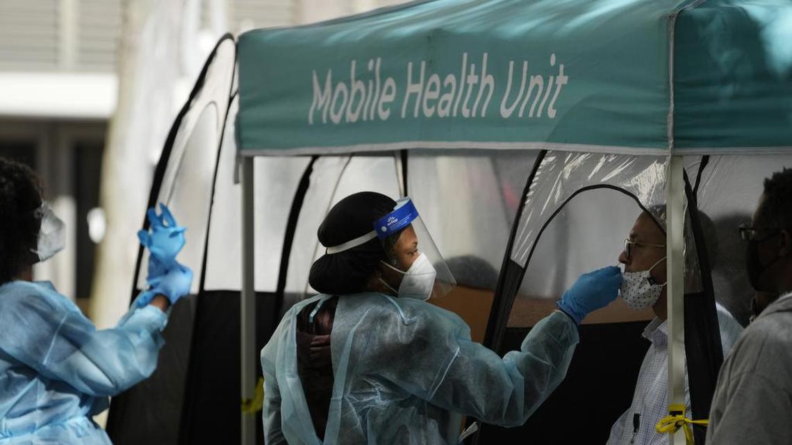 A man is tested for COVID-19 at a walk-up testing site run by Nomi Health in downtown Miami on Dec. 28, 2021.