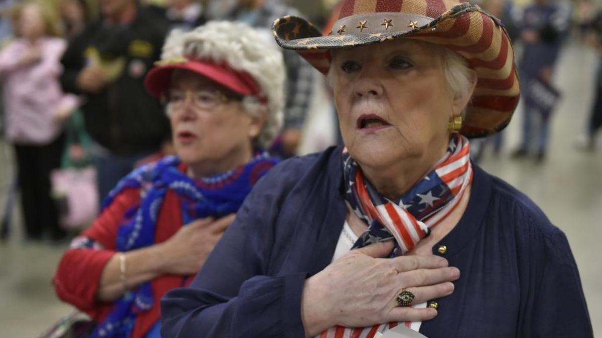 Seguidores de Donald Trump escuchan el himno nacional al inicio de evento en el Centro Agrícola WNC en Fletcher, Carolina del Norte el 21 de octubre, 2016.
