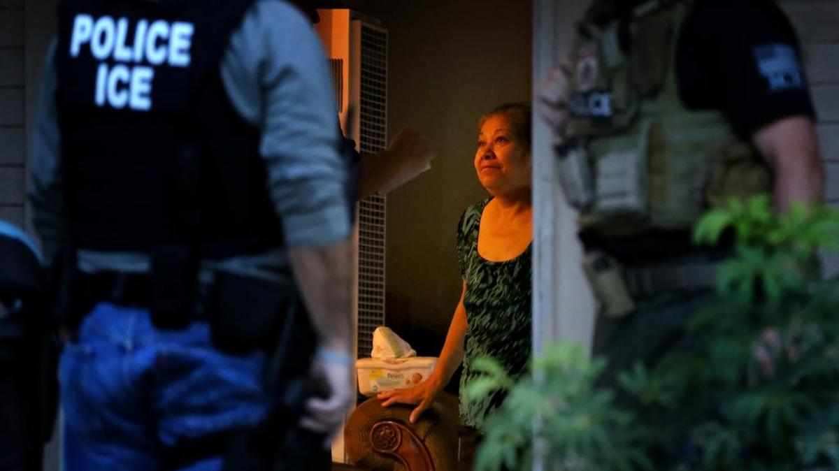 ICE agents in  Riverside, California, speak with the mother of an immigrant who was detained and deported. 