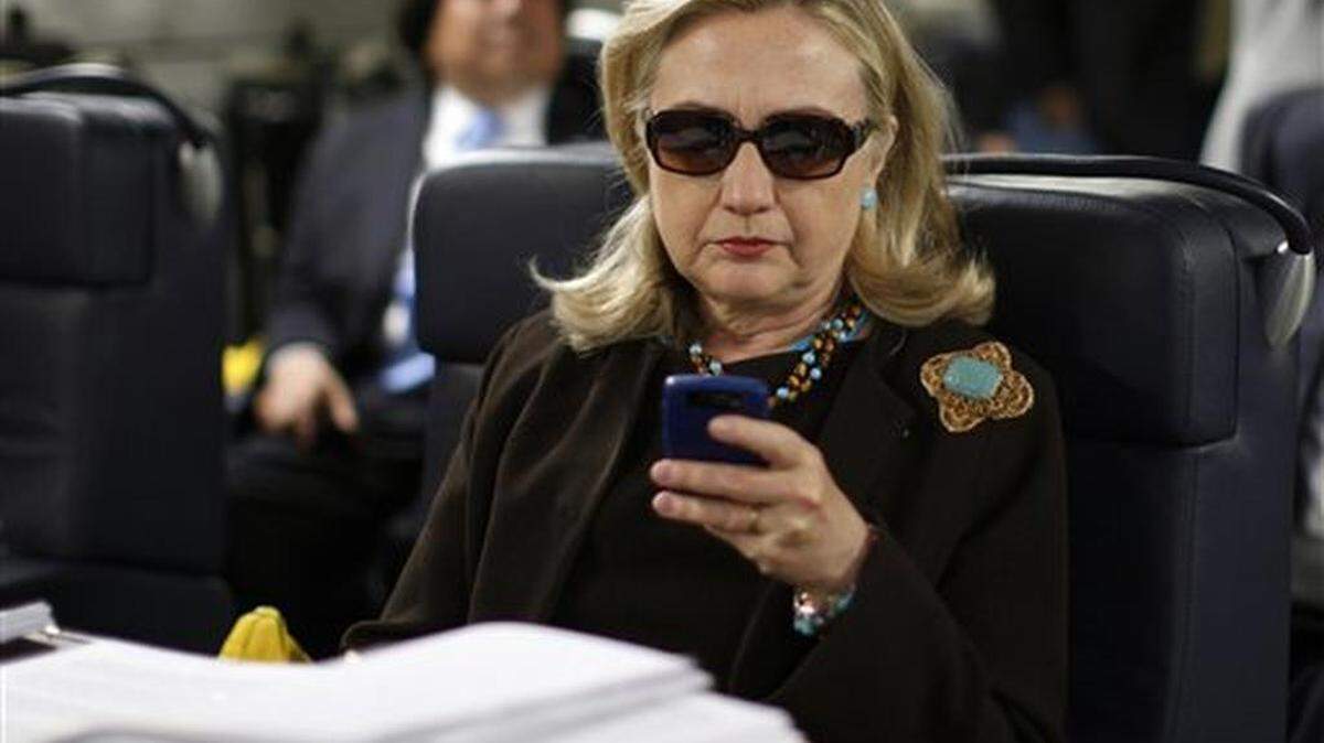 En esta foto del 18 de octubre de 2011, se ve a la entonces secretaria de Estado Hillary Rodham Clinton revisando su Blackberry desde un avión militar C-17 antes de partir de Malta hacia Libia. Un reporte del inspector general del Departamento de Estado difundido el 25 de mayo de 2016 rebeló más detalles del servidor privado que usó Clinton para administrar sus comunicaciones mientras era la principal diplomática de EEUU.