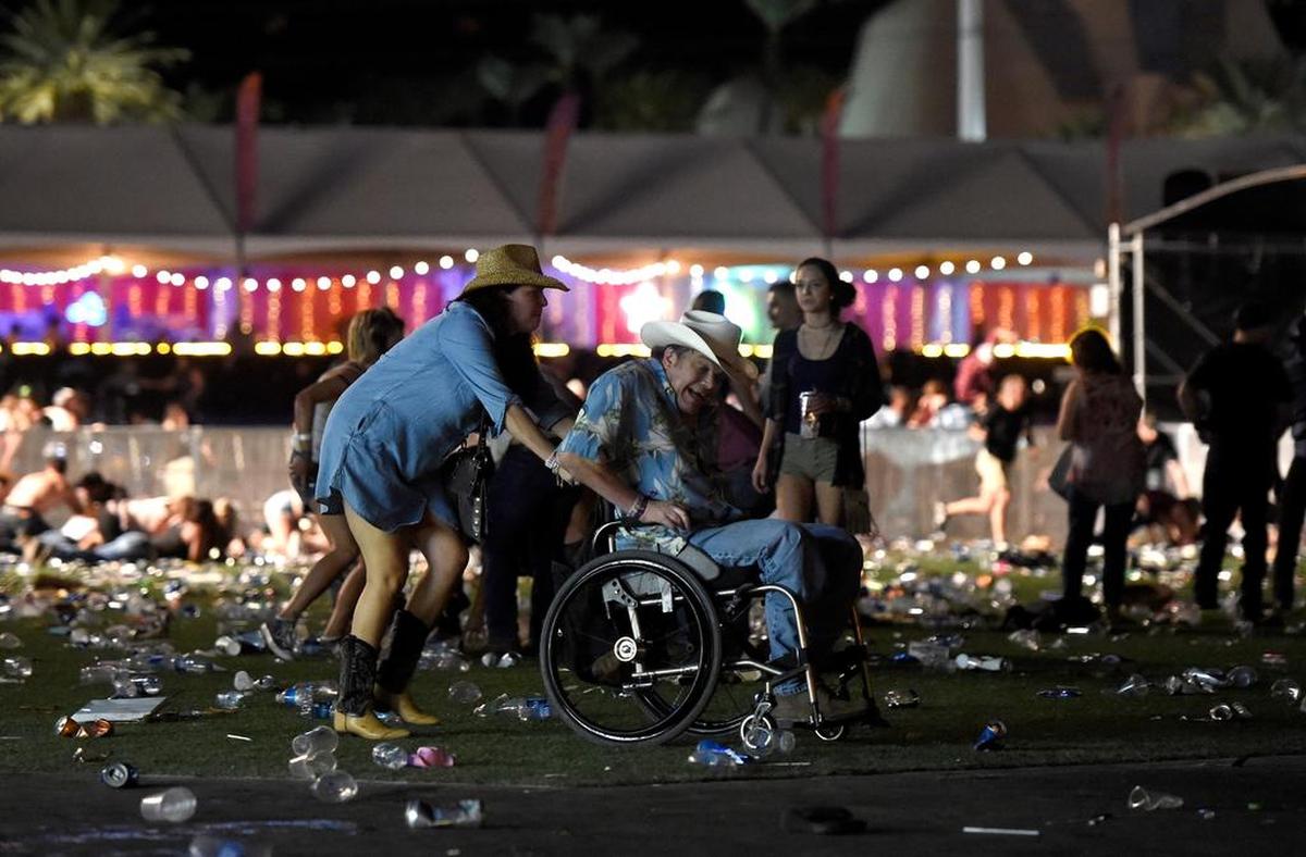 Un hombre en una silla de ruedas huye del festival de la música country después de que se registrara un tiroteo el 1 de octubre de 2017 en Las Vegas, Nevada.