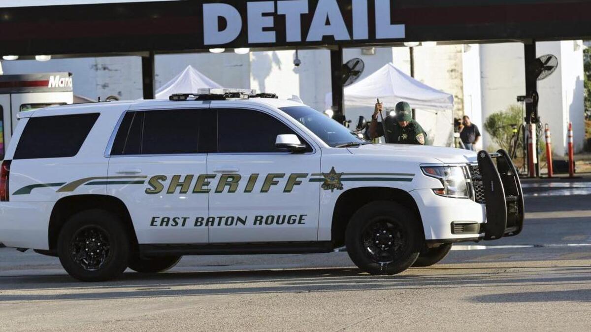 Un adjunto de la Oficina del Sheriff del distrito de Baton Rouge limpia su vehículo en el exterior de la gasolinera donde tres policías fueron asesinados durante un tiroteo en Baton Rouge, en el estado de Luisiana, en el sur de Estados Unidos hoy, 18 de julio de 2016.