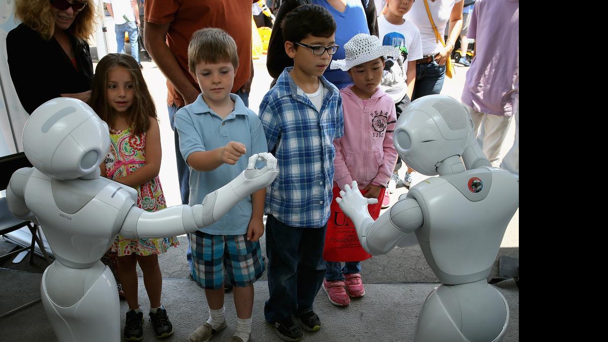 
Niños interactúan con dos de los 24 robots que compitieron en Pomona, California, donde se seleccionaron los que mejor podrían realizar tareas de rescate en una situación de tragedia.
