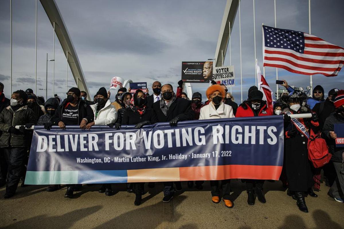WASHINGTON, DC - JANUARY 17: (center left to right) Yolanda Renee King, Arndrea Waters King, and Martin Luther King III, lead the annual D.C. Peace Walk: Change Happens with Good Hope and a Dream across the Frederick Douglass Memorial Bridge for Dr. Martin Luther King Day on January 17, 2022 in Washington, DC. Democrats are trying to pass John R. Lewis Voting Rights Act this week which will counter the various voting suppression laws passed in multiple Republican states in the wake of the 2020 elections. (Photo by Samuel Corum/Getty Images)
