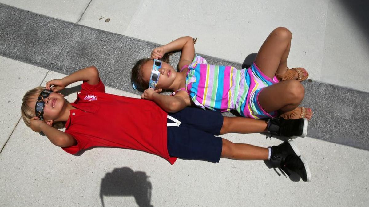 SebastianStetter, de 6, y Amelia Pierce Gray, de 5, ven el eclipse solar en el Museo Frost en el centro de Miami el lunes 21 de agosto de 2017.