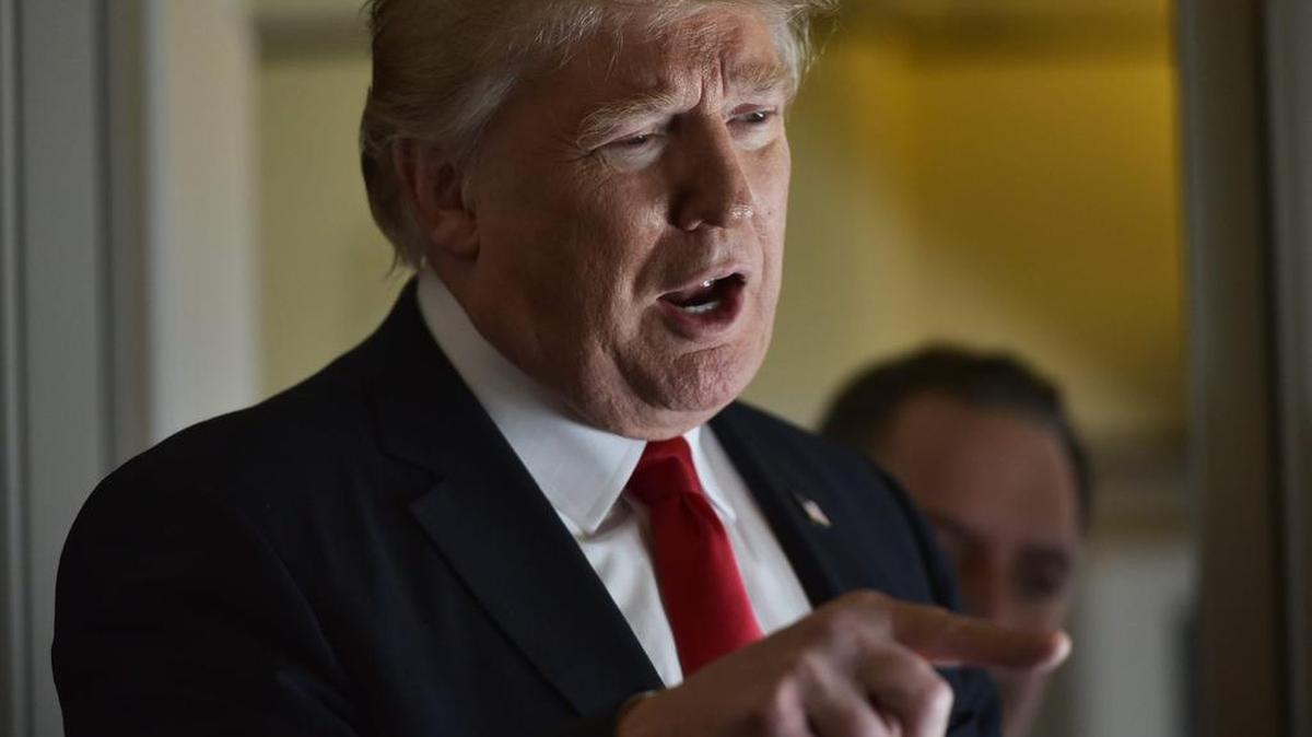 Esta foto de archivo tomada el 3 de febrero de 2017 muestra al presidente de los Estados Unidos, Donald Trump, hablando con periodistas a bordo del Air Force One antes de partir de la Base de la Fuerza Aérea Andrews en Maryland, con destino a Palm Beach, Florida.