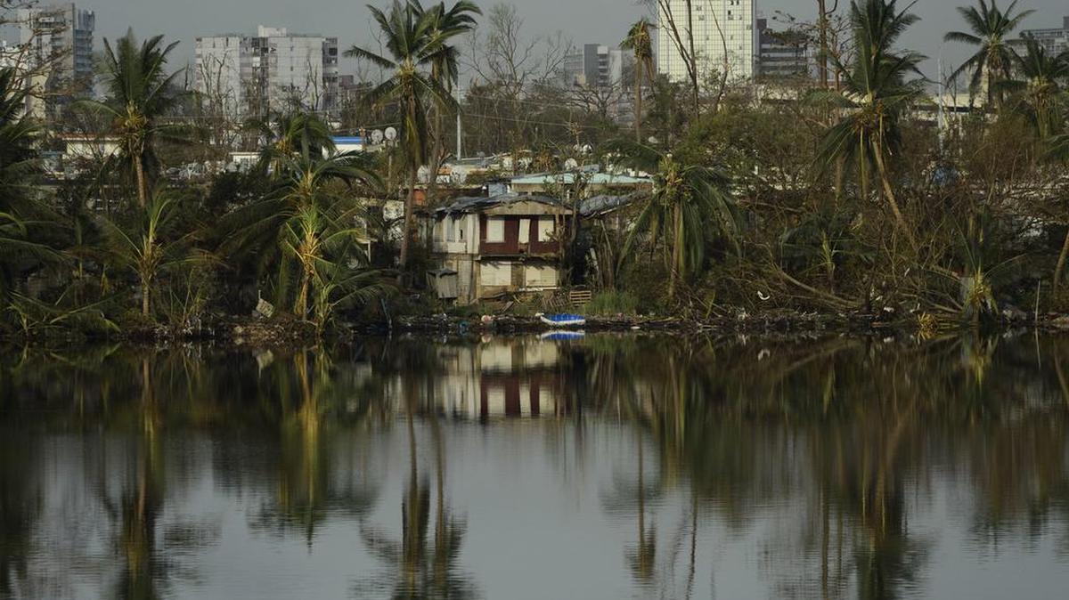 Los árboles se reflejan en el agua en la comunidad de Buena Vista después del huracán María en San Juan, Puerto Rico, el domingo, 24 de septiembre de 2017.