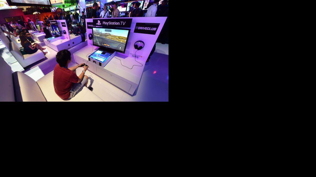 
Varias personas prueban las consolas de televisión Playstation en la exposición anual de videojuegos E3 en Los Angeles en junio pasado.
