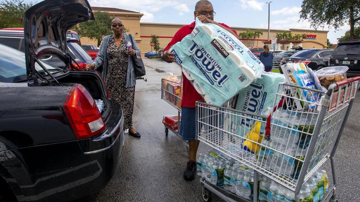 Miami-Dade residents Jackie and James Silva load their car after shopping to prepare for potential landfall by Hurricane Ian at Costco in Miami, Florida, on Sept. 25, 2022. The Silvas were shopping to assist friends and family who might be in need of extra supplies.