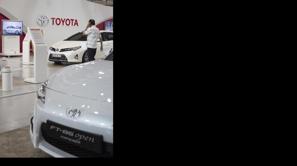 
Foto del pasado mes de agosto muestra un visitante que examina un Toyota Auris Touring Sports en una salón de Tokio. 
