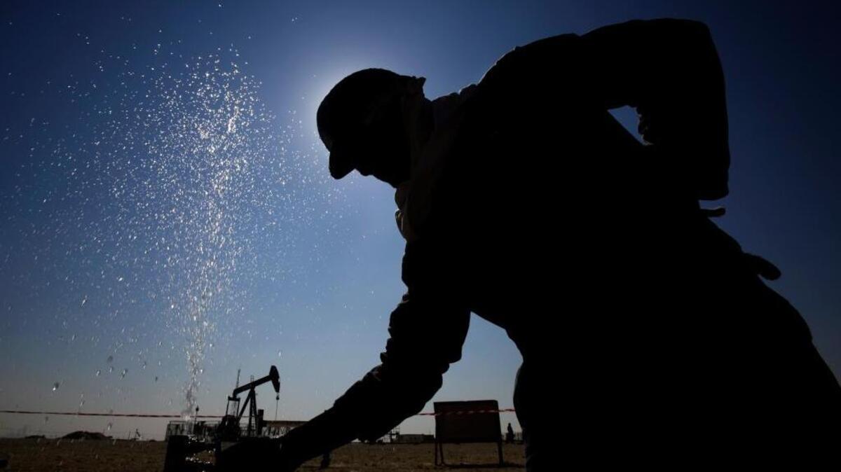Un trabajador ajusta en febrero una válvula en un oleoducto, en el campo petrolero de Sakhir, Bahrain.