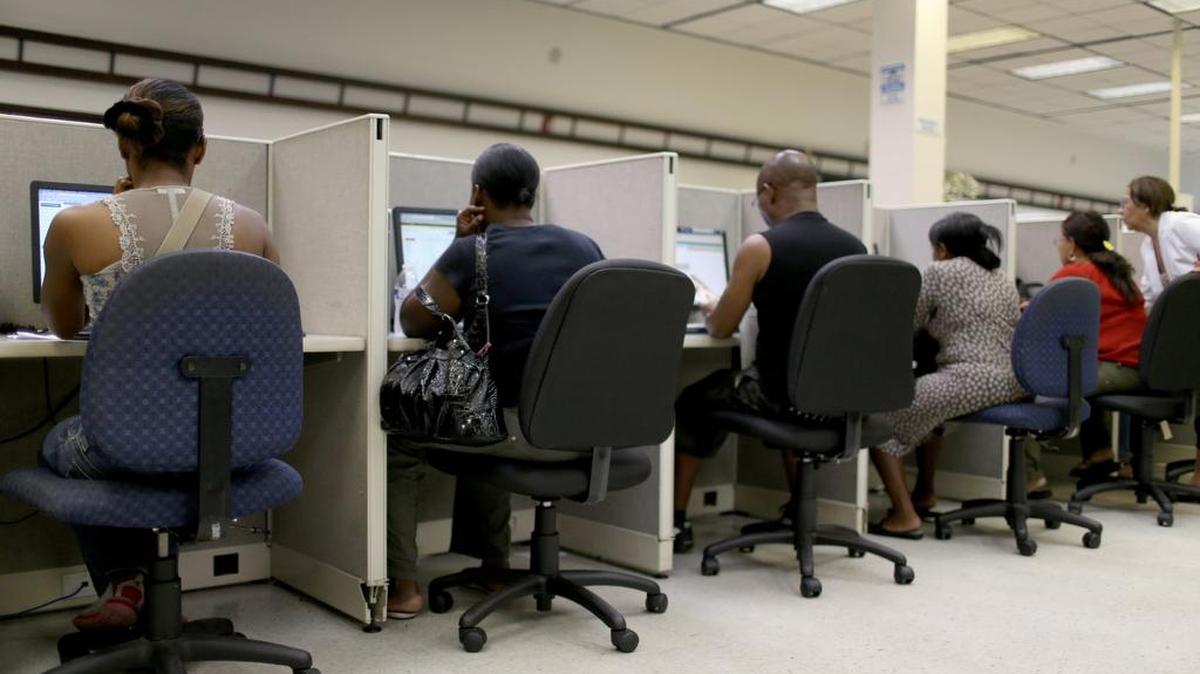 Personas buscando oportunidades de empleos en el sistema computarizado de CareerSource Florida, en Miami. La economía de Estados Unidos creó menos empleo del esperado en agosto