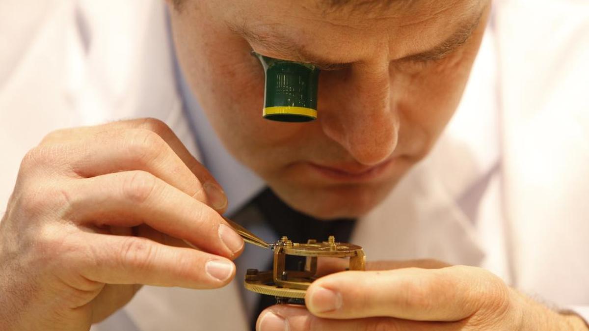 Un relojero trabaja en un modelo de pulsera en la feria de Baselworld en Suiza.