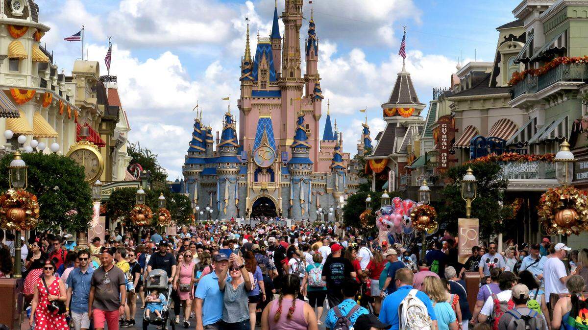 Crowds fill Main Street USA in front of Cinderella’s Castle at the Magic Kingdom on the 50th anniversary of Walt Disney World, in Lake Buena Vista, Fla., on Friday, Oct. 1, 2021.