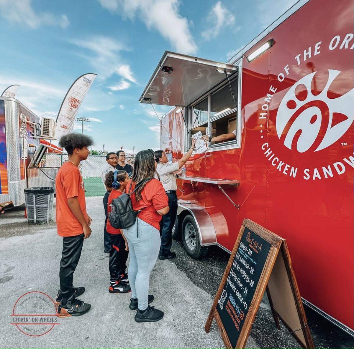Young customers from Hialeah line up to order food from the Chick-fil-A food truck on July 4, 2023 in Milander Park.