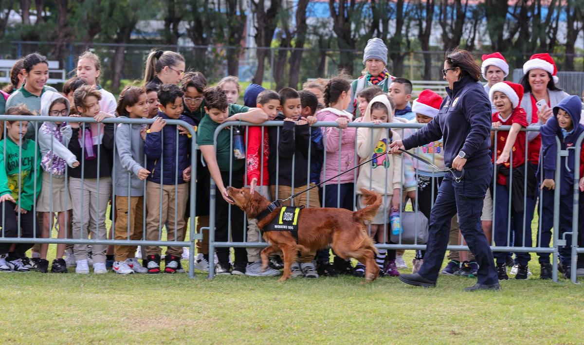 Bárbara González-Tamburello, bombero ingeniero de Hialeah y adiestradora del canino junto a su perro Blaze, rescatista participaron en una manifestación ante estudiantes de diferentes escuelas de Hialeah durante un evento de colecta de juguetes en el parque del Centro de Arte y Entretenimiento del Milander, el miércoles 6 de diciembre de 2023. .