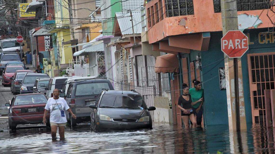 Residents deal with navigating high water throughout San Juan as Hurricane Maria left many streets flooded and blocked by fallen power lines, trees, and debris while Puerto Rico tries to recover from the Category 4 storm on Thursday, September 21, 2017.